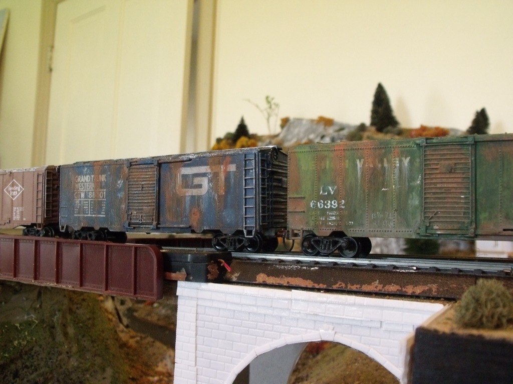 The two boxcars closest are both scavenged from cheap train sets. With some weathering, they look pretty decent. They may not hold up on close scrutiny but in a passing train, it doesn't matter.
